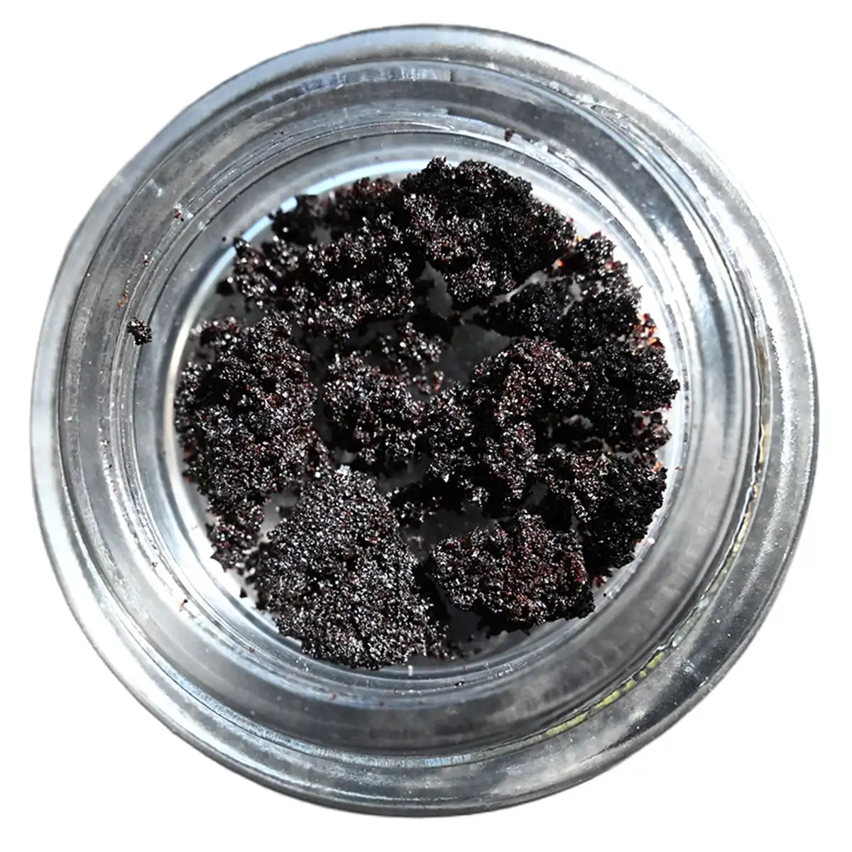 A jar with a fine dark brown crystalline substance.